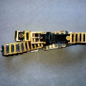 Black leather belt with gold buckle hardware